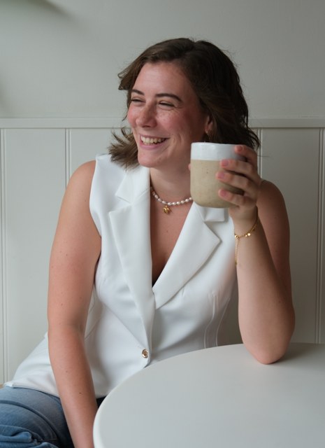 Britt, one of our travelling family assistants, smiling over a cup of coffee